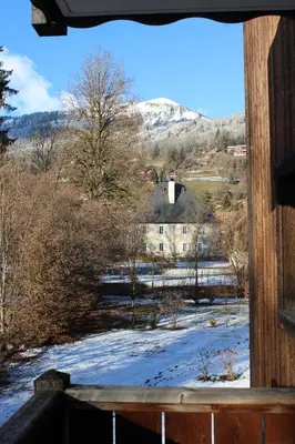 a view from a window of a building with a snow covered field at Chardons Argentés in Samoëns