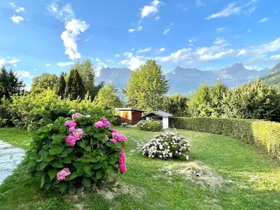 a garden with pink flowers and a fence at Chalet familial Saint-Gervais in Saint-Gervais-les-Bains