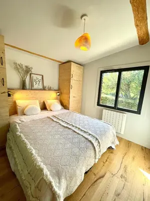 a bedroom with a large bed and a window at Chalet familial Saint-Gervais in Saint-Gervais-les-Bains
