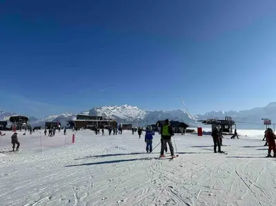 a beach with a bunch of chairs and people on it at Samoens 1600, Grand Massif in Samoëns