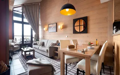 a bedroom with a large bed and a television at Résidence Pierre & Vacances Premium Les Terrasses d'Hélios in Flaine