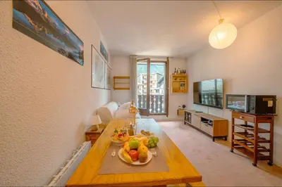 a living room with a table with fruit on it at Chamonix Sud - Bâtiment Iris 374 - Happy Rentals in Chamonix-Mont-Blanc