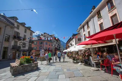a group of people sitting at tables on a city street at Chamonix Sud - Bâtiment Iris 374 - Happy Rentals in Chamonix-Mont-Blanc