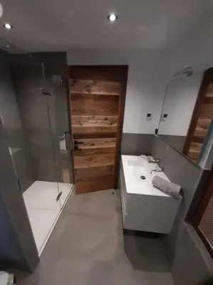 a bathroom with a white sink and a shower at Chalet Henriette by Brennus Chamonix in Chamonix-Mont-Blanc