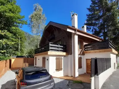 a house with a car parked in front of it at Chalet Henriette by Brennus Chamonix in Chamonix-Mont-Blanc