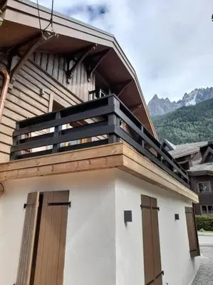 a building with a balcony on top of it at Chalet Henriette by Brennus Chamonix in Chamonix-Mont-Blanc