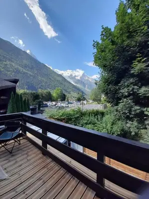 a wooden deck with a view of a mountain at Chalet Henriette by Brennus Chamonix in Chamonix-Mont-Blanc
