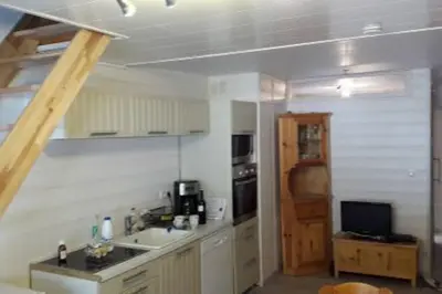 a kitchen with a sink and a stove top oven at Appartement Le Carlina 22B -MERCI DE LIRE TOUT ET disposition des chambres pour éviter une mauvaise note - Ce nest PAS un Hôtel - MINIMUM 5 nuits - sans le linge de maison - Vue sur le Criou - Sil y a de la place sur le parking, vous pouvez vous y garer in Samoëns