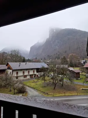 a view of a village with a mountain in the background at Appartement Le Carlina 22B -MERCI DE LIRE TOUT ET disposition des chambres pour éviter une mauvaise note - Ce nest PAS un Hôtel - MINIMUM 5 nuits - sans le linge de maison - Vue sur le Criou - Sil y a de la place sur le parking, vous pouvez vous y garer in Samoëns