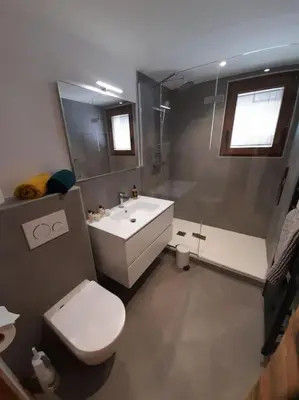 a bathroom with a white toilet and a sink at Chalet Marguerite by Brennus Chamonix in Chamonix-Mont-Blanc