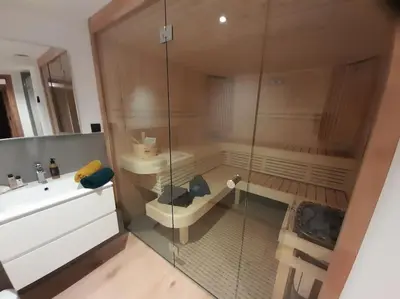 a bathroom with a shower and a sink and a toilet at Chalet Marguerite by Brennus Chamonix in Chamonix-Mont-Blanc
