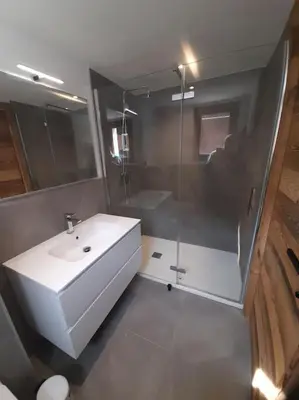 a bathroom with a white sink and a shower at Chalet Claudia by Brennus Chamonix in Chamonix-Mont-Blanc