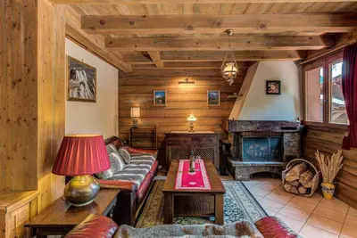 a living room with a couch and a fireplace at Chalet Blackbushe – Traditional Chalet - Alpes Travel – Sleeps 4-6 in Les Houches