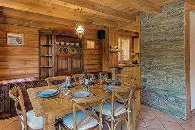 a dining room with a wooden table and chairs at Chalet Blackbushe – Traditional Chalet - Alpes Travel – Sleeps 4-6 in Les Houches