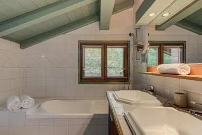 a bathroom with two sinks and a bath tub at Chalet Blackbushe – Traditional Chalet - Alpes Travel – Sleeps 4-6 in Les Houches