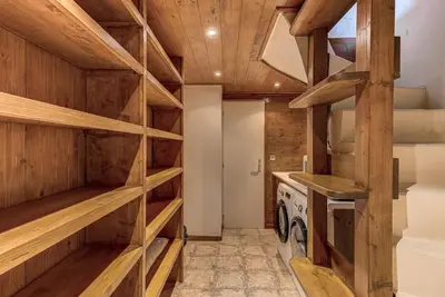 a kitchen with wooden walls and wooden shelves at Chalet Blackbushe – Traditional Chalet - Alpes Travel – Sleeps 4-6 in Les Houches