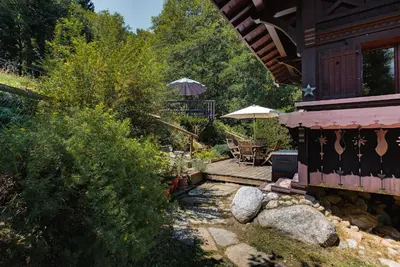 a porch of a house with a wooden deck at Chalet Blackbushe – Traditional Chalet - Alpes Travel – Sleeps 4-6 in Les Houches