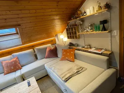 a living room with a couch with pillows on it at Appartement 6 personnes les Contamines Montjoie in Les Contamines-Montjoie