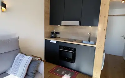 a small kitchen with a sink and a stove at Studio lumineux avec vue sur le Mont Blanc in Cordon