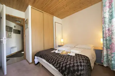 a room with two bunk beds and a chair at Résidence Igloo 3 ski in-ski out - Happy Rentals in Le Tour