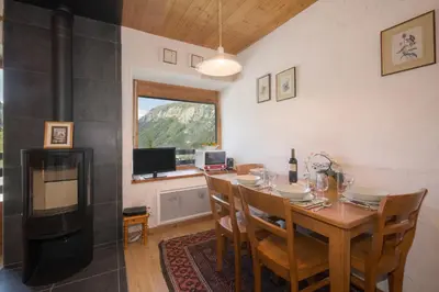 a dining room with a table and a view of a mountain at Résidence Igloo 3 ski in-ski out - Happy Rentals in Le Tour