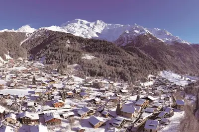 a village in the snow with mountains in the background at Montagne aux Contamines Montjoie Appartement 6-7 personnes in Les Contamines-Montjoie