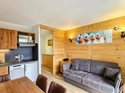 a living room with a couch and a table at Studio rénové avec cabine à Flaine, balcon ensoleillé - FR-1-425-201 in Arâches-la-Frasse