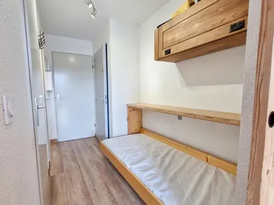 a small room with a bed and a closet at Studio rénové avec cabine à Flaine, balcon ensoleillé - FR-1-425-201 in Arâches-la-Frasse