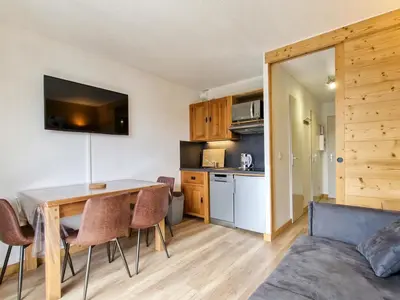 a kitchen and dining room with a table and chairs at Studio rénové avec cabine à Flaine, balcon ensoleillé - FR-1-425-201 in Arâches-la-Frasse