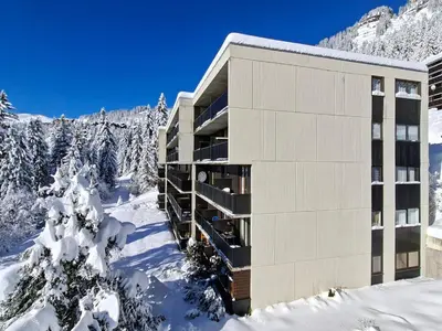 a building in the snow with snow covered trees at Studio rénové avec cabine à Flaine, balcon ensoleillé - FR-1-425-201 in Arâches-la-Frasse