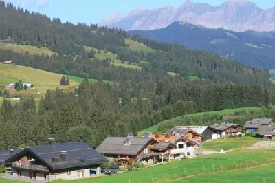 a village in a valley with mountains in the background at Appartement Rochebrune De Megève 32 - Happy Rentals in Megève