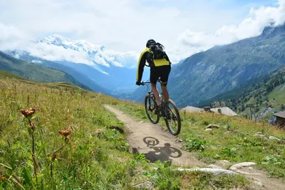 a person riding a bike down a dirt road at Appartement Rochebrune De Megève 32 - Happy Rentals in Megève
