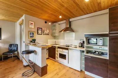 a kitchen with a counter and a chair in it at Appartement Rochebrune De Megève 32 - Happy Rentals in Megève