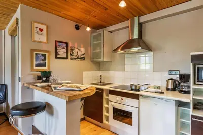 a kitchen with a counter and a stove top oven at Appartement Rochebrune De Megève 32 - Happy Rentals in Megève