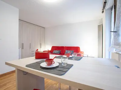 a living room with a table with two cups on it at Apartment Champraz-17 by Interhome in Chamonix-Mont-Blanc
