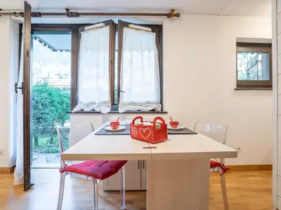 a kitchen with a table with a red purse on it at Apartment Champraz-17 by Interhome in Chamonix-Mont-Blanc