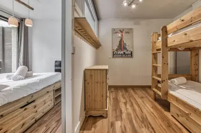 a room with two bunk beds and a ladder at Aiguille du Grépon - Bright Apartment in the Heart of Chamonix in Chamonix-Mont-Blanc