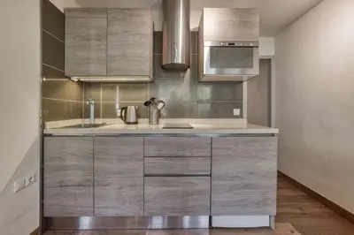 a kitchen with stainless steel cabinets and a sink at Aiguille du Grépon - Bright Apartment in the Heart of Chamonix in Chamonix-Mont-Blanc