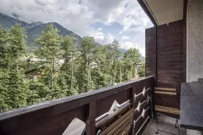 a balcony with a view of the mountains at Aiguille du Grépon - Bright Apartment in the Heart of Chamonix in Chamonix-Mont-Blanc
