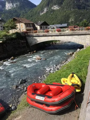 a red boat sitting on the side of a river at Lucada Les Carroz in Les Carroz d'Araches