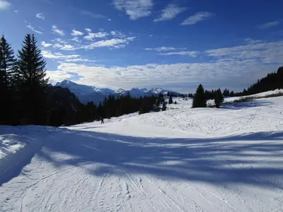 a shadow of a person on a snow covered slope at Lucada Les Carroz in Les Carroz d'Araches