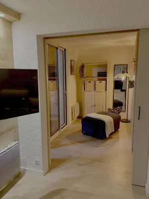 a bedroom with a bed and a living room at Les Airelles 406 in Les Carroz d'Araches