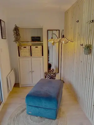 a room with a blue ottoman sitting on the floor at Les Airelles 406 in Les Carroz d'Araches