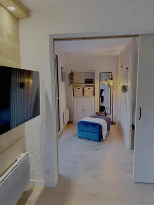 a bedroom with a bed and a room with a tv at Les Airelles 406 in Les Carroz d'Araches