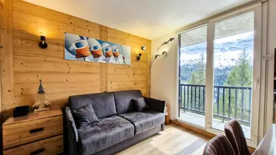 a living room with a couch and a large window at Résidence Iris - Studio entièrement rénové avec cabine · Centre station · Balcon MAE-4504 in Magland