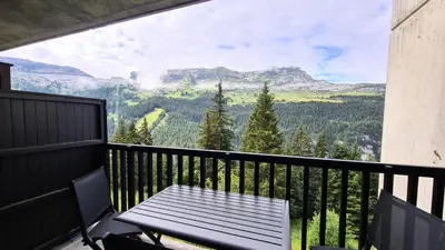 a table and chairs on a balcony with a view at Résidence Iris - Studio entièrement rénové avec cabine · Centre station · Balcon MAE-4504 in Magland
