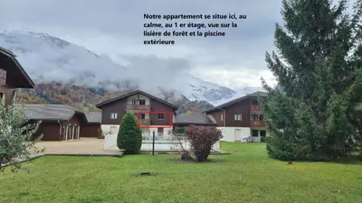 a picture of a house with mountains in the background at Bel appartement avec piscine - Le Grand Tétras in Samoëns
