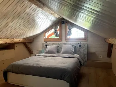 a bed in a tiny house with a window at Cosy appartement centre chamonix in Chamonix-Mont-Blanc