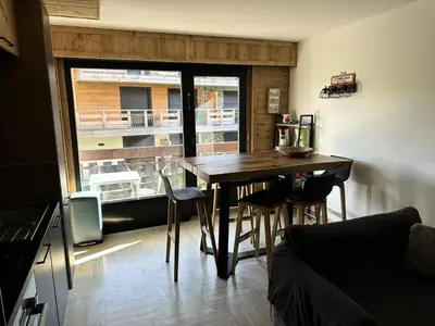 a dining room with a table and chairs and a window at Résidence La Cry - Appartement 3 pièces - 6 personnes Vue Mont-Blanc MAE-5604 in Combloux