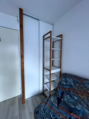 a bedroom with a bed and a book shelf at Aux Pieds des pistes en plein soleil in Les Contamines-Montjoie
